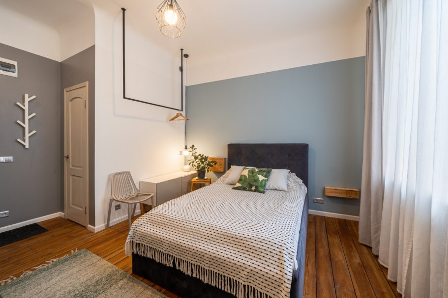 Cozy bedroom featuring a single bed, simple decor, and soft natural lighting.